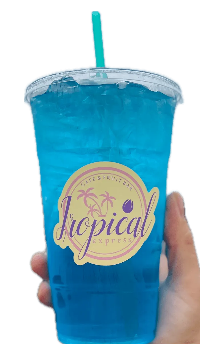 A hand holding a Tropical Express cup of April Showers — a blue LOTUS energy drink with white peach and blue raspberry