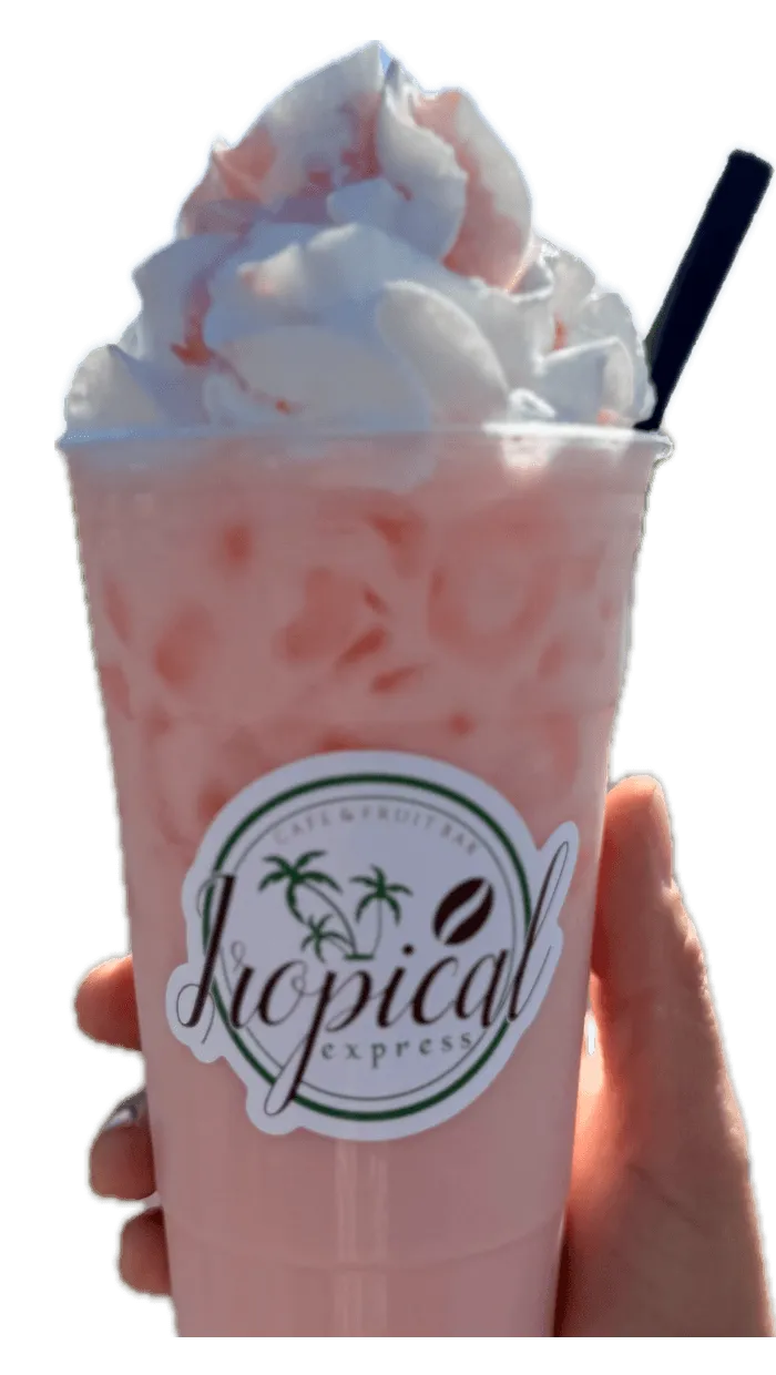 A hand holding a Tropical Express cup of Cherry Wave — a creamy pink cherry, coconut and pineapple drink with cream