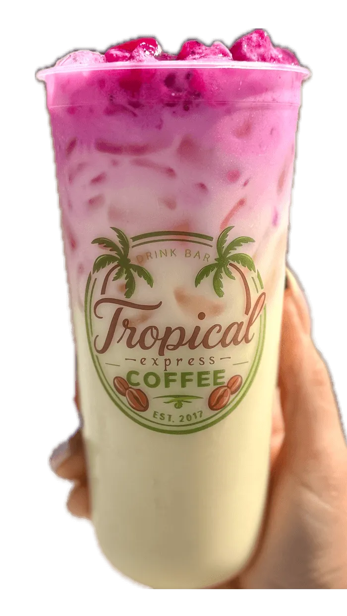 A hand holding a Tropical Express cup of Golden Bloom — a golden LOTUS energy drink with peach, mango and passion fruit topped with dragon fruit