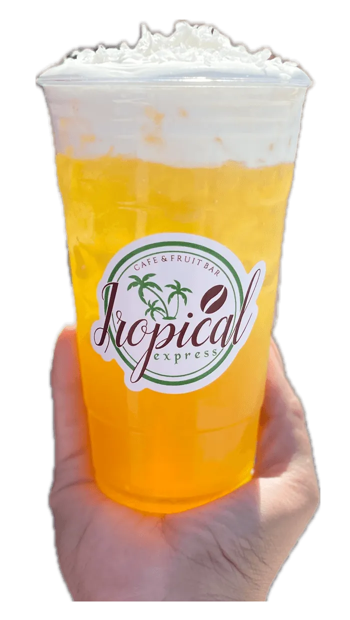 A hand holding a Tropical Express cup of Piña Colada — a yellow pineapple and coconut drink topped with vanilla cold foam