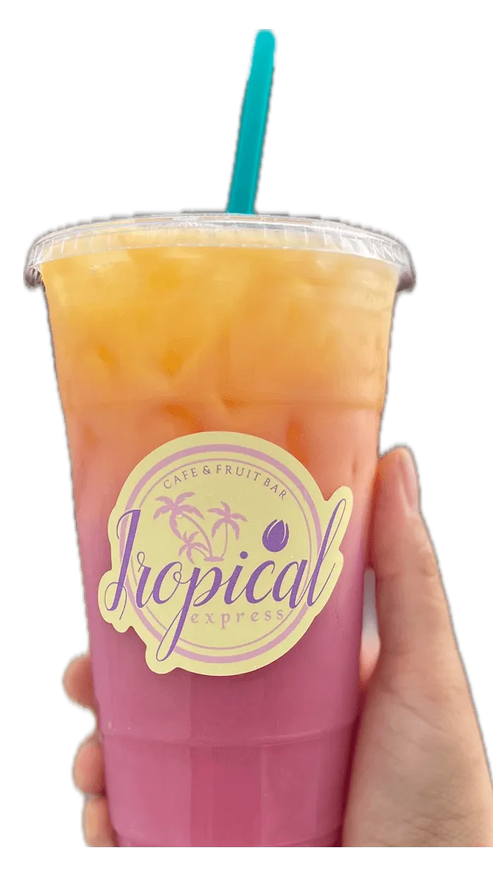 A hand holding a Tropical Express cup of Sunny Days — a creamy desert pear, guava and passion fruit drink with coconut milk topped with orange juice