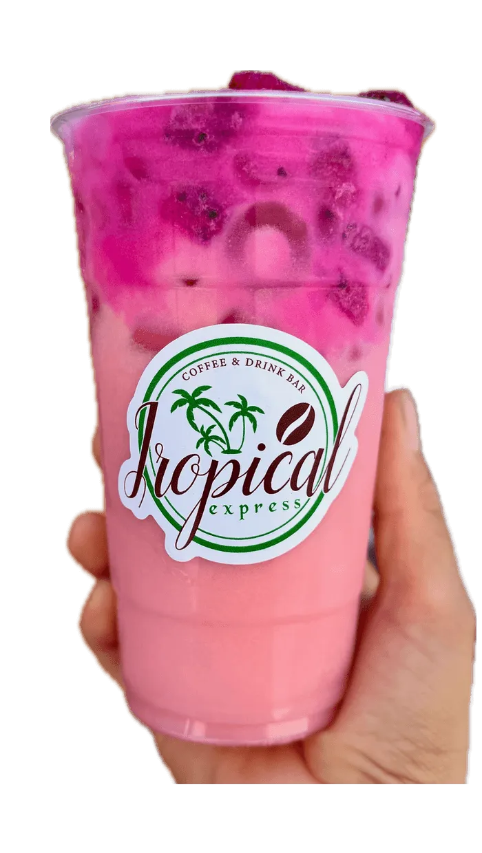 A hand holding a Tropical Express cup of Sunset Sky — a pink dragon fruit, passion fruit and strawberry drink topped with dragon fruit pieces