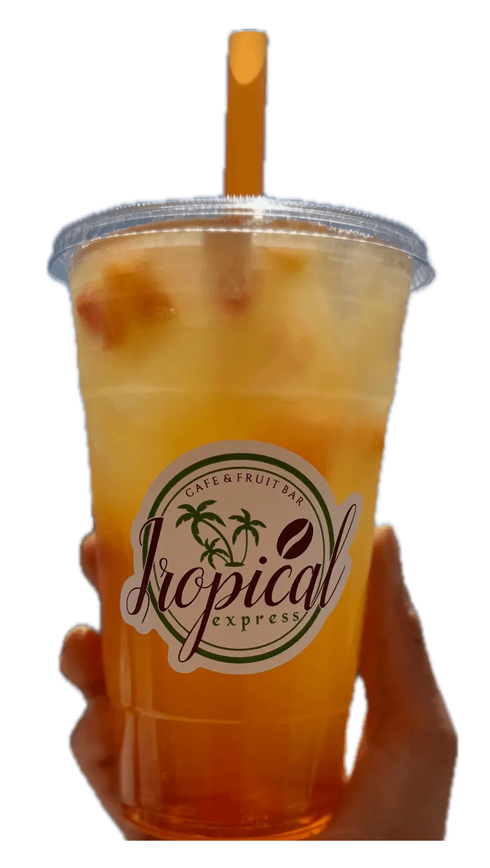 A hand holding a Tropical Express cup of Sunshine Energy — a golden peach, mango and pineapple drink topped with orange juice